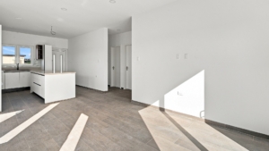 Reina Sophia Model Luca Unit 20 open interior in Aruba with tiled flooring, kitchen island, windows, sliding doors, and an unfurnished living area.