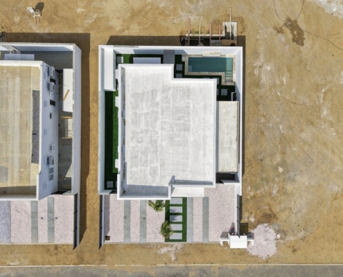 Top-down aerial view of Reina Sophia Model Luca Unit 24 in Aruba showing the flat white roof, enclosed outdoor areas, and small pool.